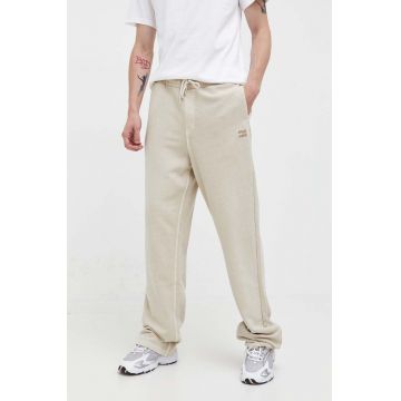 Tommy Jeans pantaloni de trening din bumbac culoarea bej, neted