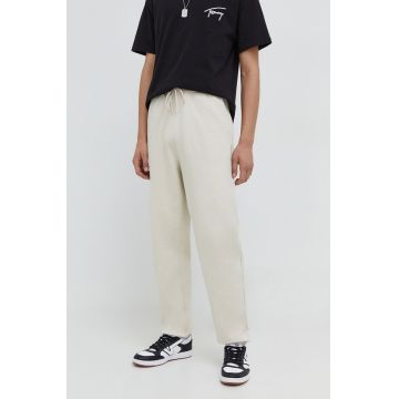 Tommy Jeans pantaloni de trening din bumbac culoarea bej, uni DM0DM18378