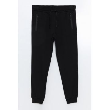 Pantaloni de trening conici cu buzunare cu fermoar