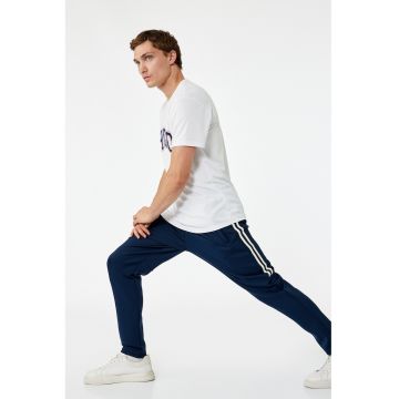 Pantaloni conici de trening cu dungi laterale